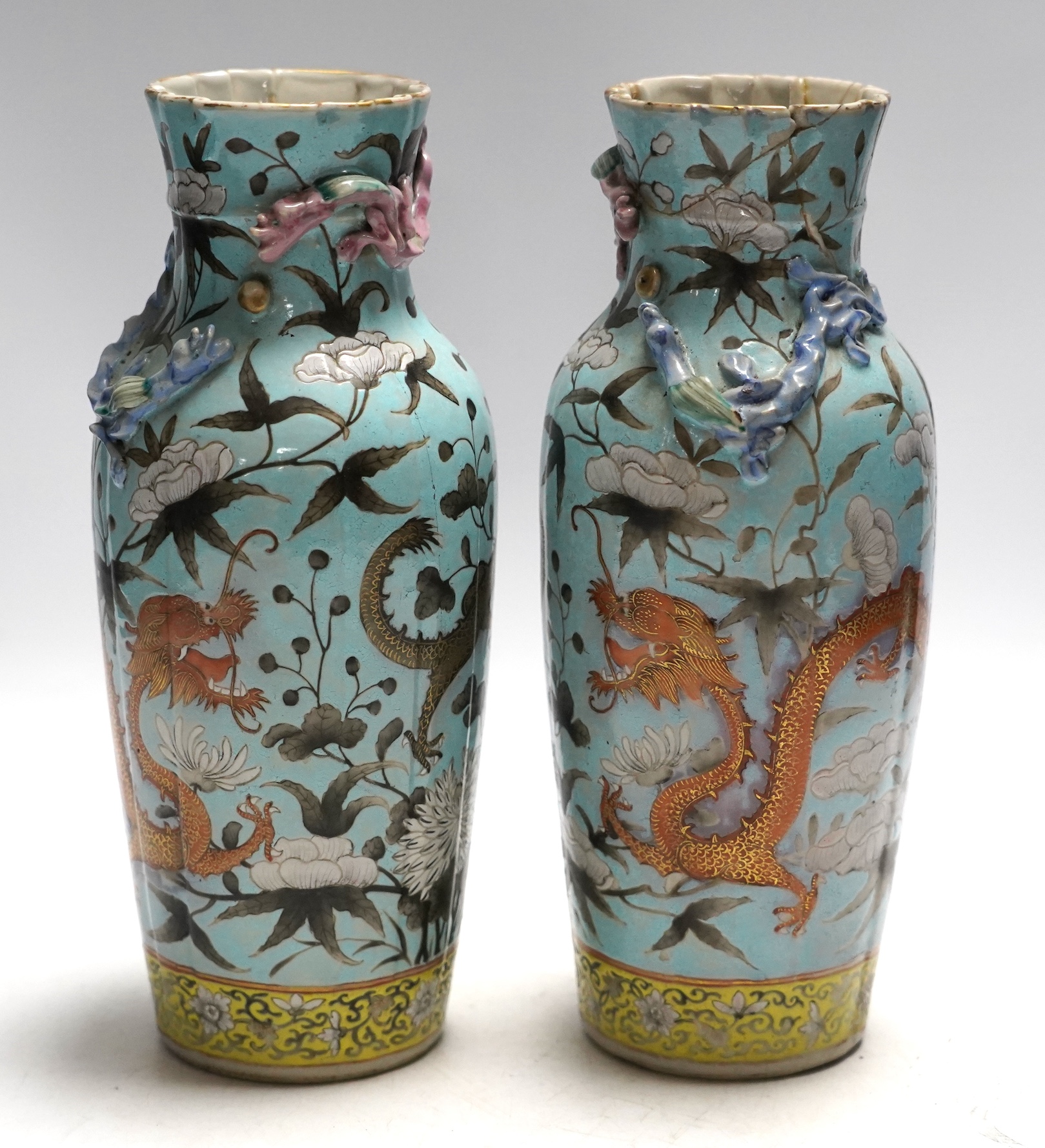 A pair of late 19th century Chinese blue glazed ‘dragon’ vases, 26cm high